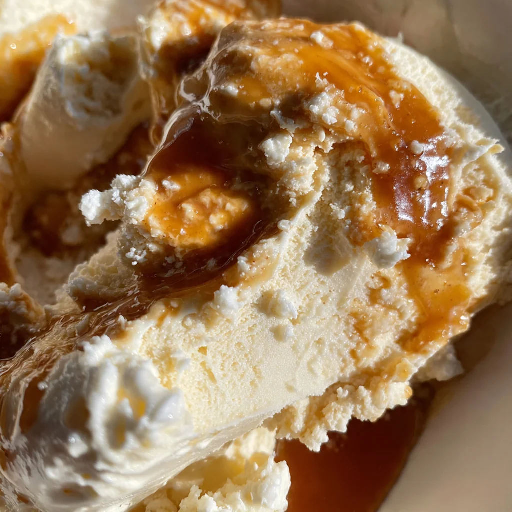 A slice of pound cake generously covered in warm bourbon-infused caramel butter sauce